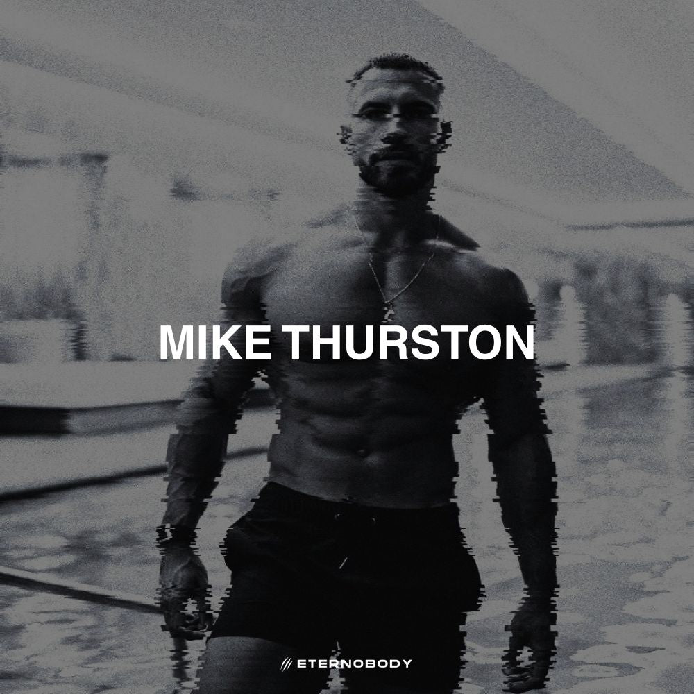  Black and white image of a shirtless Mike Thurston emerging from water, with a pixelated effect on the water. "MIKE THURSTON" text overlays the image.